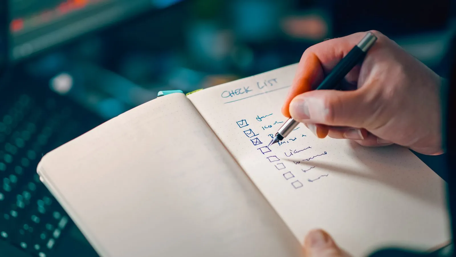 Working through a change of address checklist in a notebook when moving house