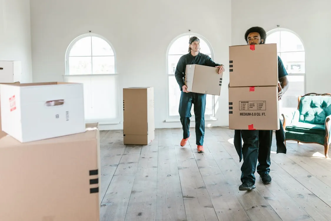 Professional Brisbane removalists carefully loading wrapped furniture onto a moving truck