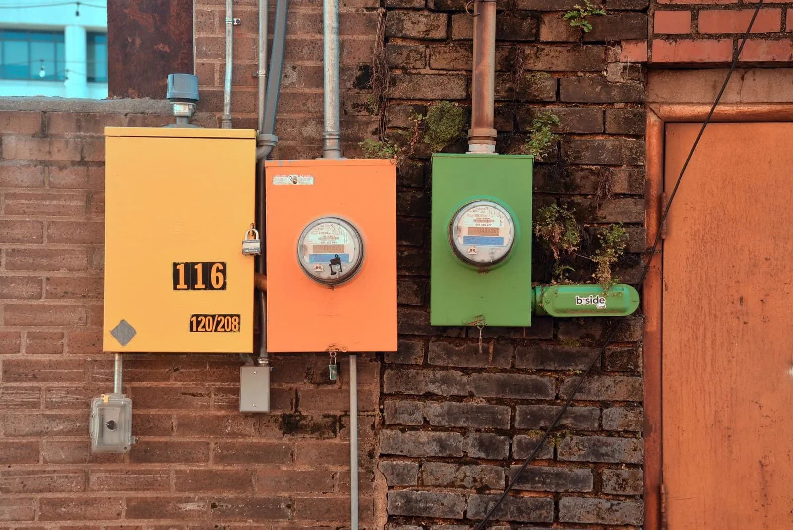 Rows of utility meter boxes on a brick wall, like those connected when setting up power and gas in a new Queensland home